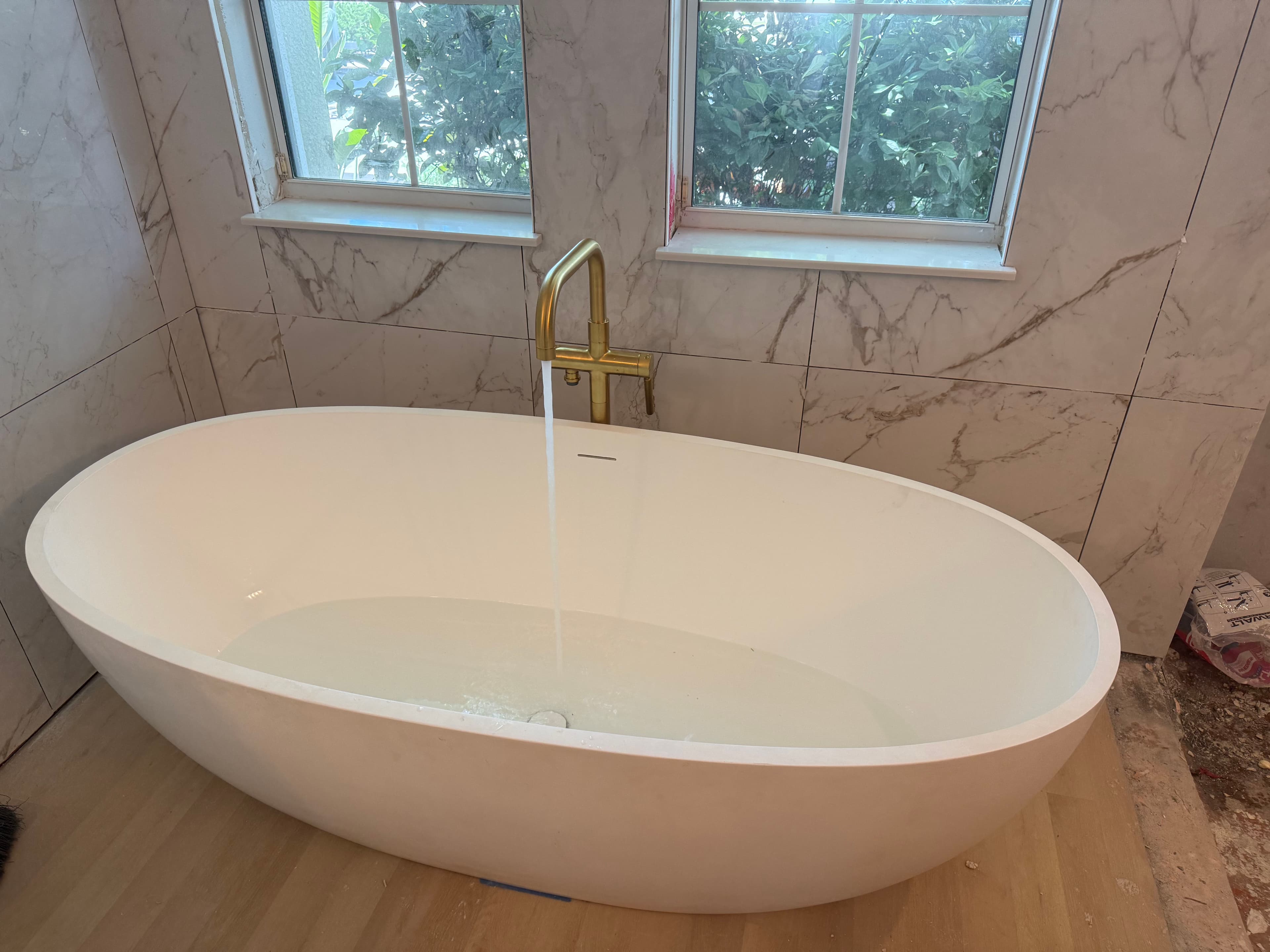 Project 300 lb Stone Resin Tub Install with Kohler Gold Brass Fixtures image