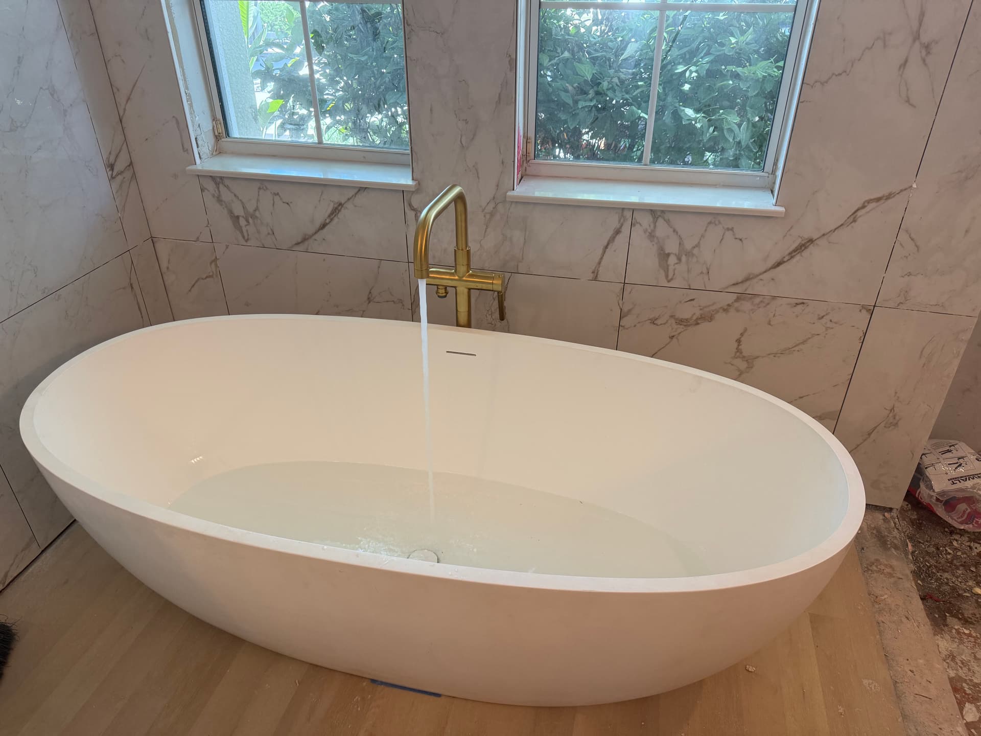 300 lb Stone Resin Tub Install with Kohler Gold Brass Fixtures image